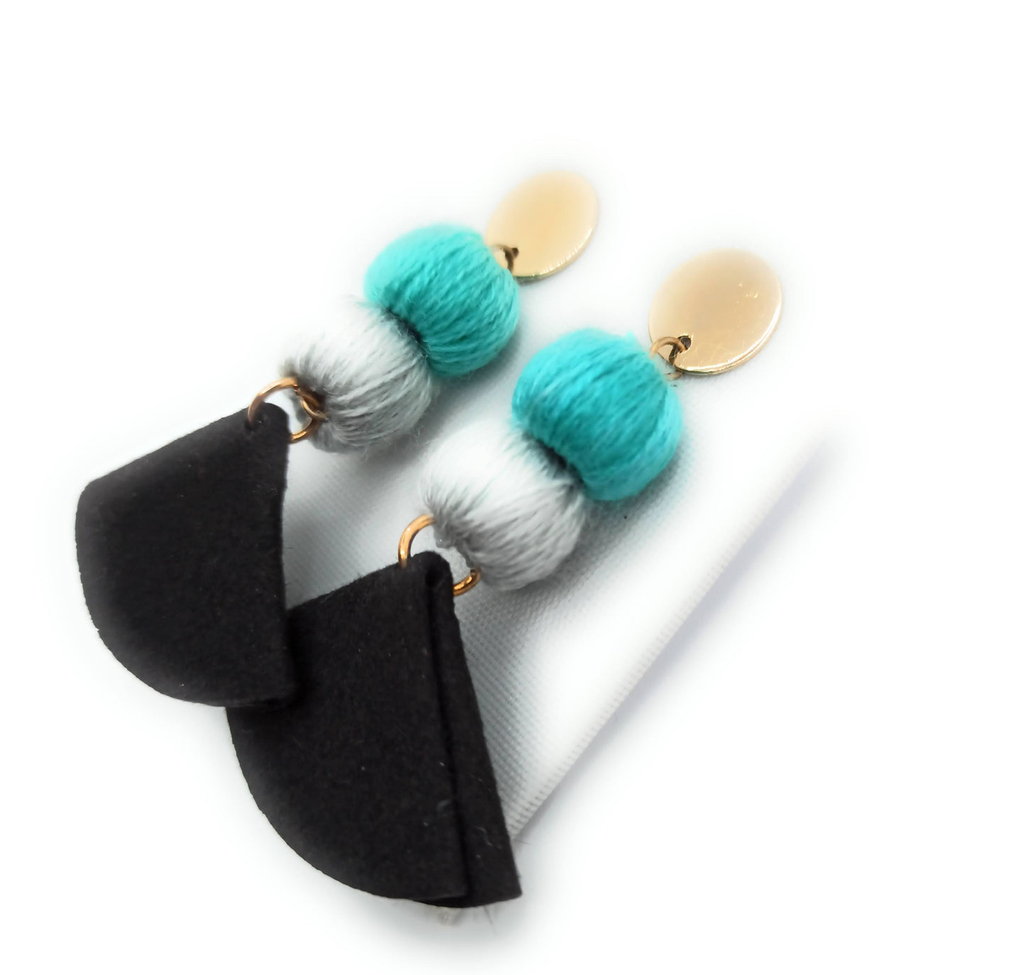 Pendientes largos y ligeros · Pompones Celeste Gris Negro