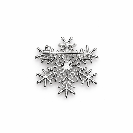 Broche plateado en forma copo de nieve con cristales facetados y circonitas brillantes