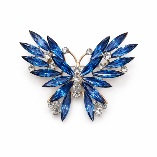 Broche joya de mariposa dorada con cristales azules y circonitas