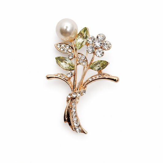Broche joya floral dorado con detalles en verde, cristales y perla
