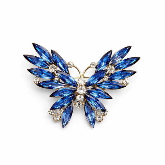 Broche joya de mariposa dorada con cristales azules y circonitas