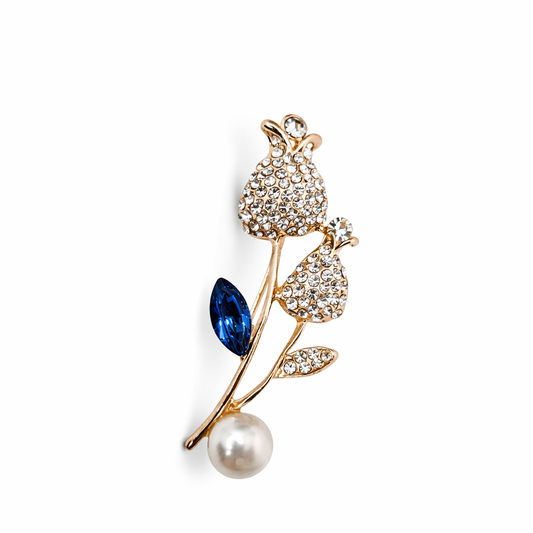 Broche joya dorado forma floral de tulipán con detalles en azul, cristales y perla