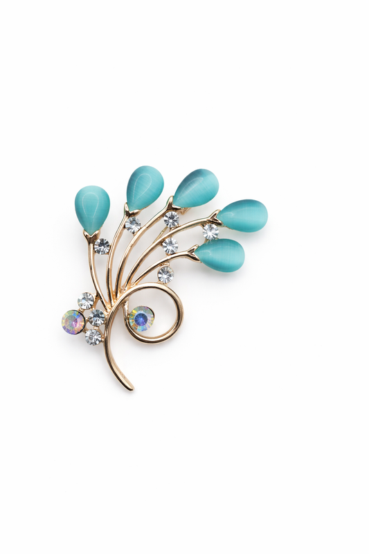 Broche joya floral dorado con detalles en celeste y cristales brillantes